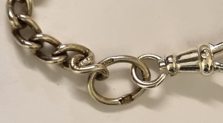 Silver ungraduated watch chain with 'T' bar and snap and indistinct hallmarking.  Length 9", weight 12 grams.