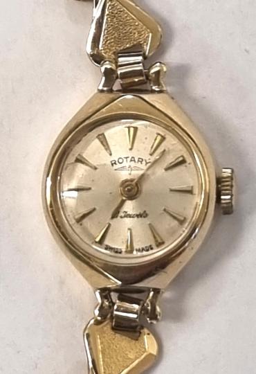 Ladies Swiss Rotary 9ct gold cased manual wind wrist watch on gold plated bracelet. Signed silvered dial with polished gilt hour markers and matching hands. 21 jewel jewelled lever AS movement calibre 1012 with case back numbered 45181 and hallmarked for London c1962.