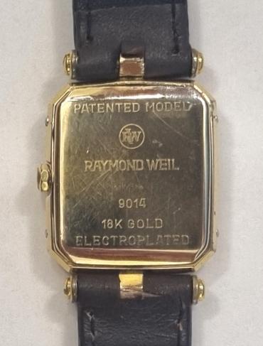 Modern Ladies 18k gold plated quartz wrist watch by Raymond Weil of Geneva on a brown leather strap with gilt buckle. Champagne coloured dial with black Roman hours on a polished gilt chapter ring with matching gilt hands.