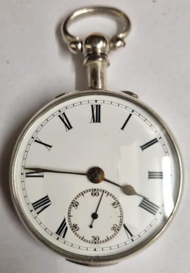 Late English silver pair case key wound lever pocket watch by William Ehrhardt, hallmarked throughout for Birmingham c1919. Domed glass over white enamel dial with black Roman hours and gilt spear and shaft hands with blued subsidiary seconds hand. Plain undecorated back plate numbered #540821 and plain undecorated cock piece with going barrel lever movement..