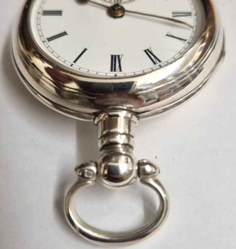 Late English silver pair case key wound lever pocket watch by William Ehrhardt, hallmarked throughout for Birmingham c1919. Domed glass over white enamel dial with black Roman hours and gilt spear and shaft hands with blued subsidiary seconds hand. Plain undecorated back plate numbered #540821 and plain undecorated cock piece with going barrel lever movement.