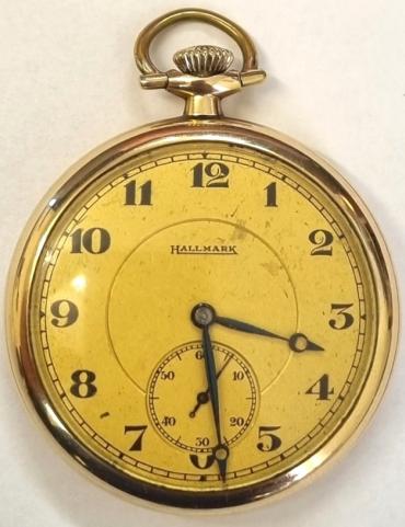 Hallmark gold plated dress pocket watch with top wind and time change circa 1920/30s. Signed champagne coloured dial with black Arabic hours and blued steel moon style hands with subsidiary seconds dial at 6 o/clock. Signed adjusted 17 jewel jewelled lever double roller movement with split bi-metallic balance and breguet overcoil hairspring with micro adjuster and numbered 3664671. Signed gold plated case back guaranteed for 20 years and numbered 19178806.